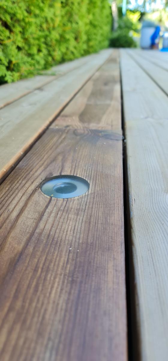 a terrace light recessed horizontally into the terrace planks