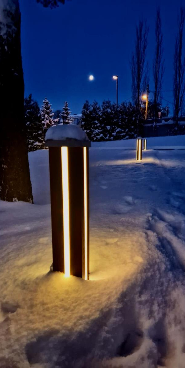 wooden bollard lights in snow